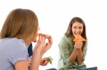 Smiling Teenage Girls Eating Pizza Stock Photo