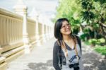 Woman Tourist With Camera Smile In The Thai Temple Stock Photo