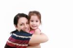 Loving Mother Hugging Her Daughter Stock Photo