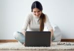 Beautiful Young Woman Working On Her Laptop At Home Stock Photo