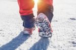 View Of Walking On Snow With Snow Shoes And Shoe Spikes In Winte Stock Photo