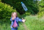 Girl Catching A Plastic Bottle Stock Photo