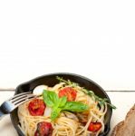 Spaghetti Pasta With Baked Cherry Tomatoes And Basil Stock Photo