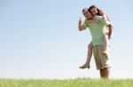 Man Piggybacking His Girlfriend Stock Photo