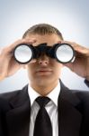 Young Businessman Using Binoculars Stock Photo