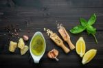 The Ingredients For Green Pesto Sauce On Dark Wooden Background Stock Photo