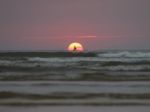 Sailing Boat And Sun Rising In Sea Stock Photo