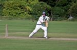 Playing Cricket On The Green At Bamburgh Stock Photo