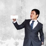 Asian Businessman Showing White Blank Note Stock Photo