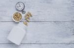 Herbal Capsule With Vintage Watch And Whit Plastic Bottle Stock Photo