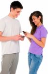 Teenage Couple Holding Smartphone Stock Photo