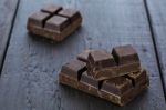 Dark Chocolate Pieces On Wooden Table Background Stock Photo