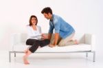 Loving Couple Sitting In Sofa Stock Photo