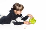 Little Girl Saving Money In Piggy Bank Stock Photo