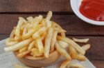 French Fries And Sauce On Wooden Stock Photo