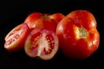 Tomatoes On Black Stock Photo