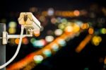 Back View Of Cctv Camera With Night City Bokeh Stock Photo