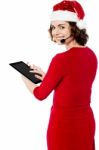 Female Santa Browsing On Her Tablet Pc Stock Photo