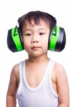 Little Asian Boy In A White Singlet Wearing Earmuffs Stock Photo