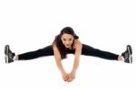 Flexible Woman Stretching Her Legs Stock Photo