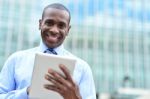 Handsome Man Using His Tablet Computer Stock Photo