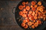 Carrots And Bacon In The Pan On The Metal Background Stock Photo