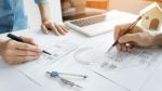 Architects Engineer Discussing At The Table With Blueprint - Clo Stock Photo