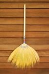 Broom On Wooden Wall Stock Photo