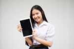 Portrait Of Thai High School Student Uniform Beautiful Girl Using Her Tablet Stock Photo