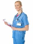 Experienced Female Doctor With Clipboard Stock Photo