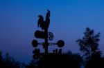 Silhouette Wheather Vane At Dawn Stock Photo