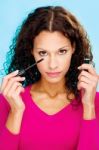 Brunette Woman Holding Mascara Stock Photo