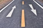 Asphalt Road And White Arrow Sign Marking On Road Surface Stock Photo