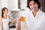 Young Couple In Kitchen Stock Photo