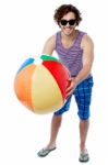 Man With A Colorful Big Beach Ball Stock Photo