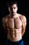 Beautiful And Muscular Man In Dark Background Stock Photo