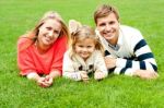 Smiling Young Family In Outdoors Stock Photo