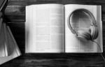 Concept Of Audiobook. Books On The Table With Headphones Put On Stock Photo