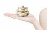 Golden Crown Cosmetic Jar On Hand Isolated Stock Photo