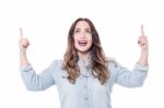 Young Woman Pointing Upwards Stock Photo