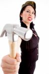 Young Violent Female Wearing Army Cap And Striking With Hammer Stock Photo