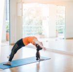 Asian Woman Doing Yoga Indoors Stock Photo