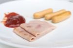 Sliced Ham And Sausage On White Dish Stock Photo