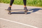 Young Woman Skateboarding In The Park Stock Photo