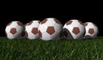 Brown Soccer Balls On A Green Grass Stock Photo