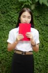 Thai Adult Student University Beautiful Girl Reading Red Book Stock Photo