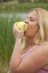 Pregnant Woman Eating Apple Stock Photo