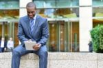 Relaxed Businessman Using His Tablet Pc Stock Photo