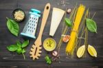 The Thin Spaghetti On Black Wooden Background. Yellow Italian Pa Stock Photo