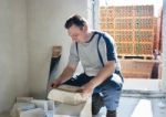 Man Worker Measures The Ruler Silicate Brick Stock Photo